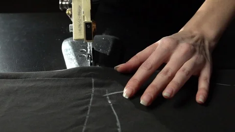 Tailoring process. Cutting cloth with electric circular knife Stock Footage 104539862
