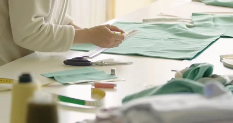 Tailoring process, female hands cutting textile with scissors in atelier Stock Footage 202517399