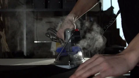 Tailoring process. Ironing new t shirt with steam Stock Footage 104539904