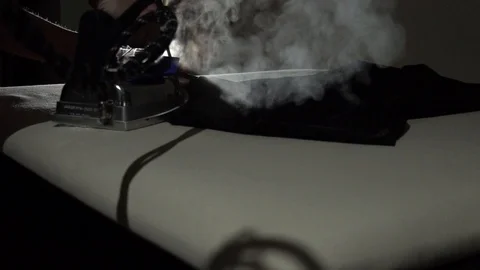 Tailoring process. Ironing new t shirt with steam Stock Footage 104539950