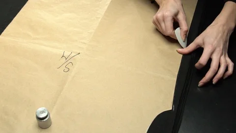 Tailoring process. Marking with paper pattern and chalk Stock Footage 104539757