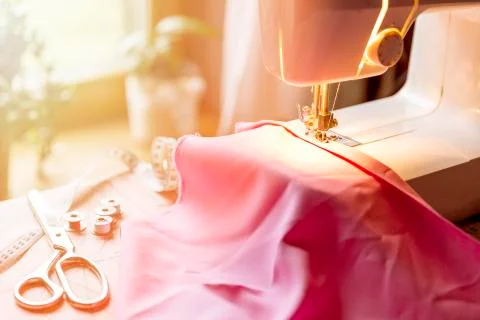 Tailoring Process - Women's hands behind her sewing machine Stock Photos