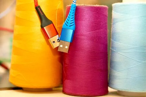 Tailoring supplies, spools of thread.Two usb cables for connection Stock Photos