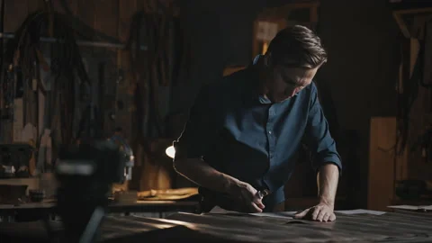 Tailoring tutorial. Professional tailor working with leather and recording video Stock Footage 164610827