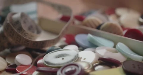 Tailor's Button Collection and Measuring Tape Revealed in Macro Close Up Stock Footage 341936493