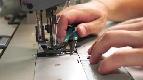 Tailor's hands cutting thread with scissors after sewing Vídeo Stock 338188790