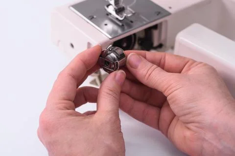 The tailor's hands hold the spool of thread Stock Photos