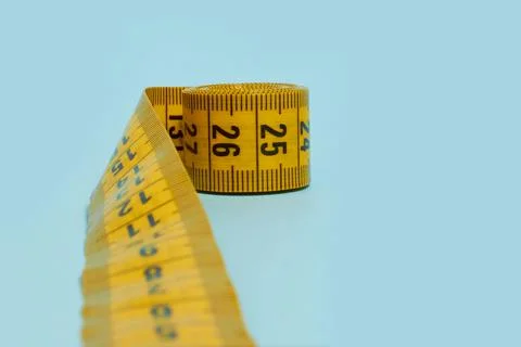 Tailor's meter on a blue background, close up Stock Photos