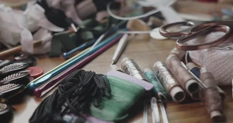 Tailor's Sewing Tools Revealed on Workbench in Close Up Slide Shot Stock Footage 342682392