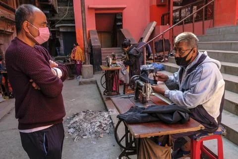 Tailors working with a sewing machine Stock Photos