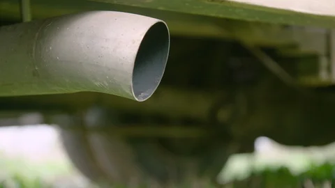 Tailpipe spews thick exhaust fumes as car starts,close-up Stock Footage