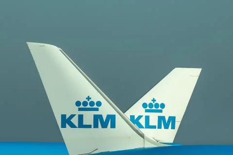 The tails of two planes passing each other on the airport Stock Photos