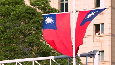 Taiwan flag waving with building in view, daytime shot Stock Footage 307570728