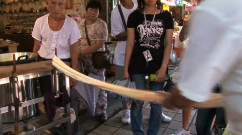 Taiwan man pulling taffy Stock Footage 265951