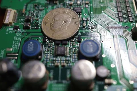 Taiwanese currency and semiconductor printed circuit boards. Stock Photos