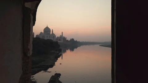 Taj mahal from arch column view on yamuna river with reflection sunset Stock Footage 120105827