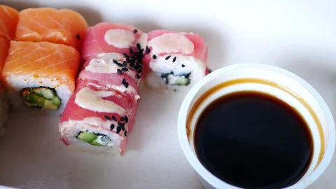 Take and dunks in soy sauce one sushi roll. Stock Footage 70674903