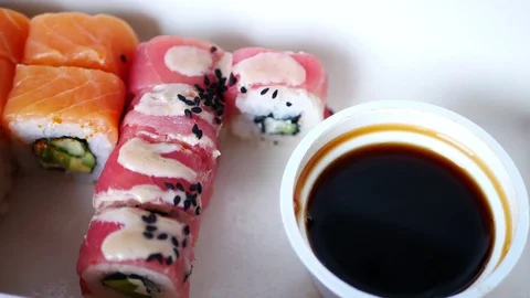 Take and dunks in soy sauce one sushi roll. Stock Footage 70674906