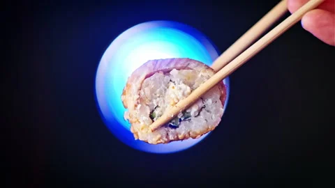 Take and Hold One Sushi Roll Using Sticks on Colorful Background, Close-Up Stock Footage 252576451