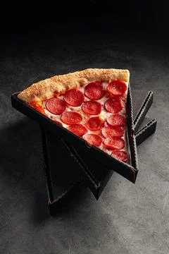 Take away box with slice of giant pepperoni pizza Stock Photos