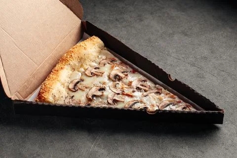 Take away box with slice of giant mushroom pizza Stock Photos