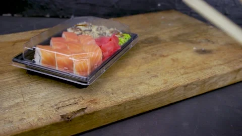 Take away sushi in plastic containers, philadelphia rolls and unagi maki, soy sa Stock Footage 138833179