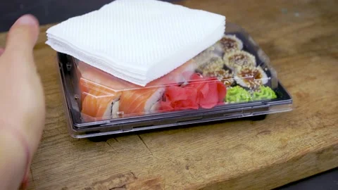 Take away sushi in plastic containers, philadelphia rolls and unagi maki, soy sa Stock Footage 138833192