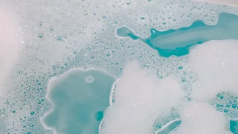 To take a bath. White foam in the bathroom. Home comfort. Stock Footage 232810097