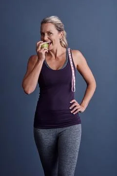 Take a bite of something healthy. Studio portrait of an attractive mature woman Stock Photos