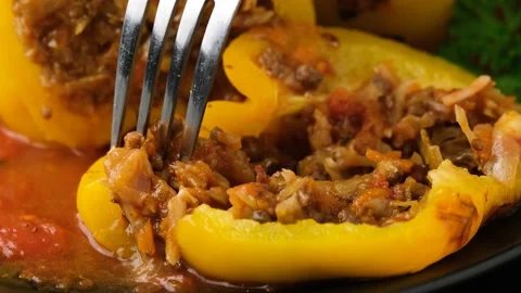 Take a bite of tasty Jack o lanterns stuffed yellow pepper for Halloween. Stock Footage 163443702