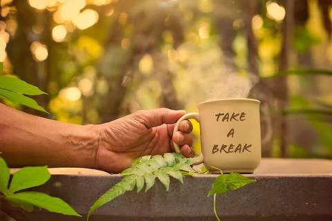 Take a break concept: having fun while enjoying a hot cup of coffee outdoors Stock Photos