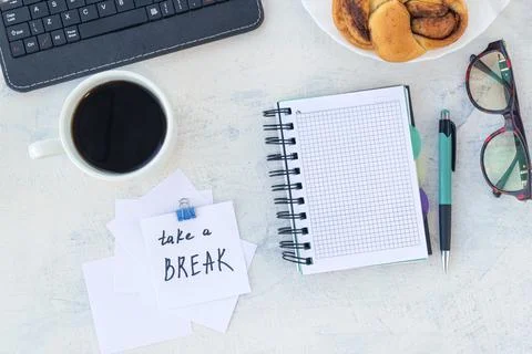 Take a break. Concept time off. Words Take a break in stiker on the working t Stock Photos