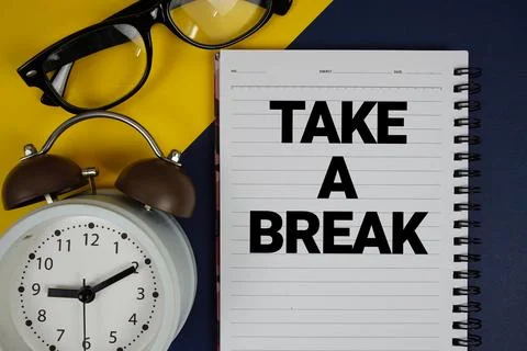 Take A Break text written on notepad with alarm clock on blue background Stock Photos