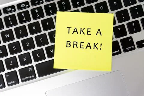 Take a break! word on stick note on top of laptop keyboard Stock Photos