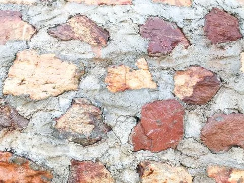 Take a close-up shot of the old patterned stone wall made of cement to keep.. Stock Photos