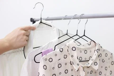 Take clothes off the hanger close-up Stock-Fotos