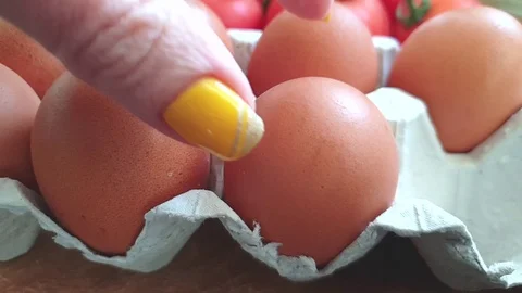 Take an egg by hand, slow motion Stock Footage 106187253