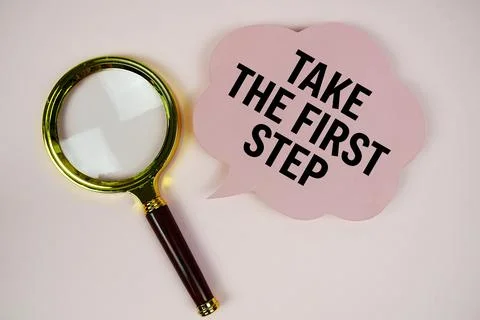 Take The First Step text with speech bubble and magnifying glass on pink ba.. Stock Photos