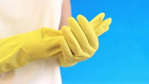 Take off gloves from hands, blue background Video stock 262163736