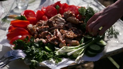 Take a hand from a plate of vegetables and fried meat and a fork. 4k, 3840x2160 Stock Footage 75463029