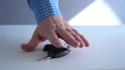 Take the key and the remote control for the car from the table. Stock Footage 220493264