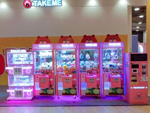 "Take Me" Arcade: Claw Machines in Indonesia Stock Photos