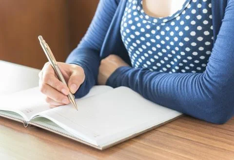 Take notes in a notebook Stock Photos