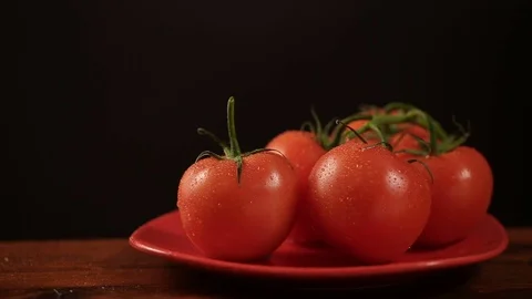 Take one ripe tomato from a red plate, and then put back Video stock 72202904