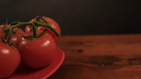 Take one ripe tomato from a red plate, and then put back Stockbeeldmateriaal 72202916