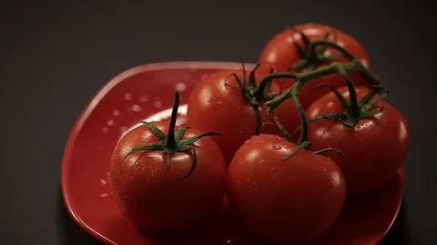 Take one ripe tomato from a red plate, and then put back Stock-Footage 72213967
