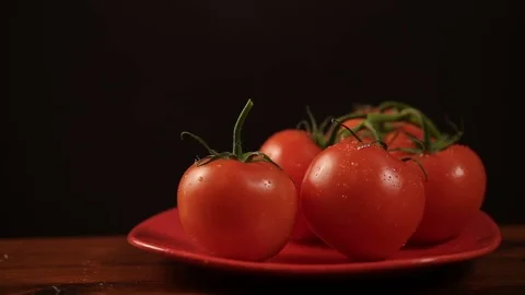 Take one ripe tomato from a red plate, and then put back Video stock 72216221