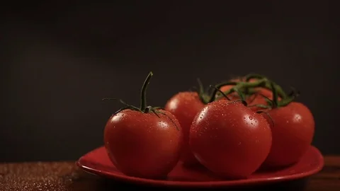 Take one ripe tomato from a red plate, and then put back Video stock 72216242