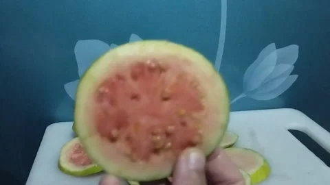 Take one round slice of red crystal guava fruit Stock Footage 229255021