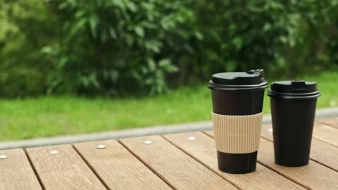 Take-out coffee cups. Paper cups with hot drink in city park close up view. Stock Footage 194537894